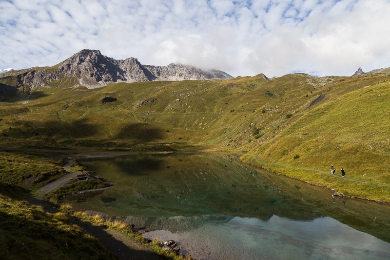 La parete rocciosa del Tschirpen si riflette nell’acqua del lago Schwelli. Molto tempo fa questo lago si trovava ancora in un bosco di pini cembri. Foto: Markus Ruff